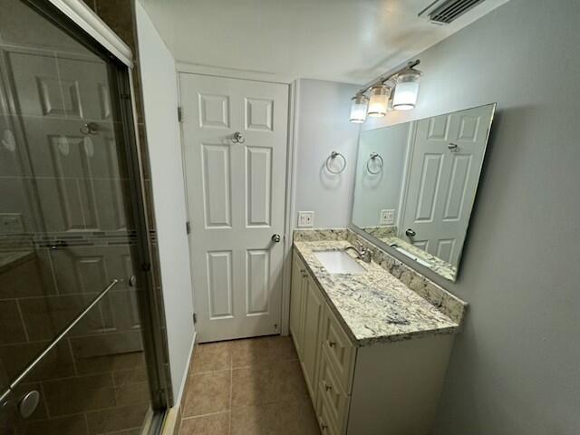 2075 SW 122nd Ave Unit 513, Miami, FL 33175 - bathroom featuring a shower stall, tile patterned floors, visible vents, and vanity