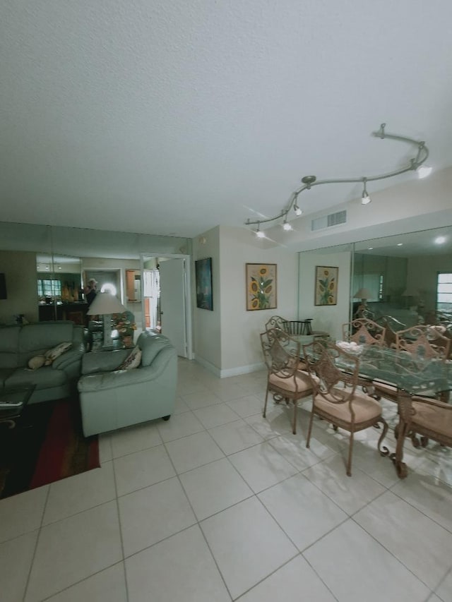 living area featuring light tile patterned flooring and healthy amount of natural light