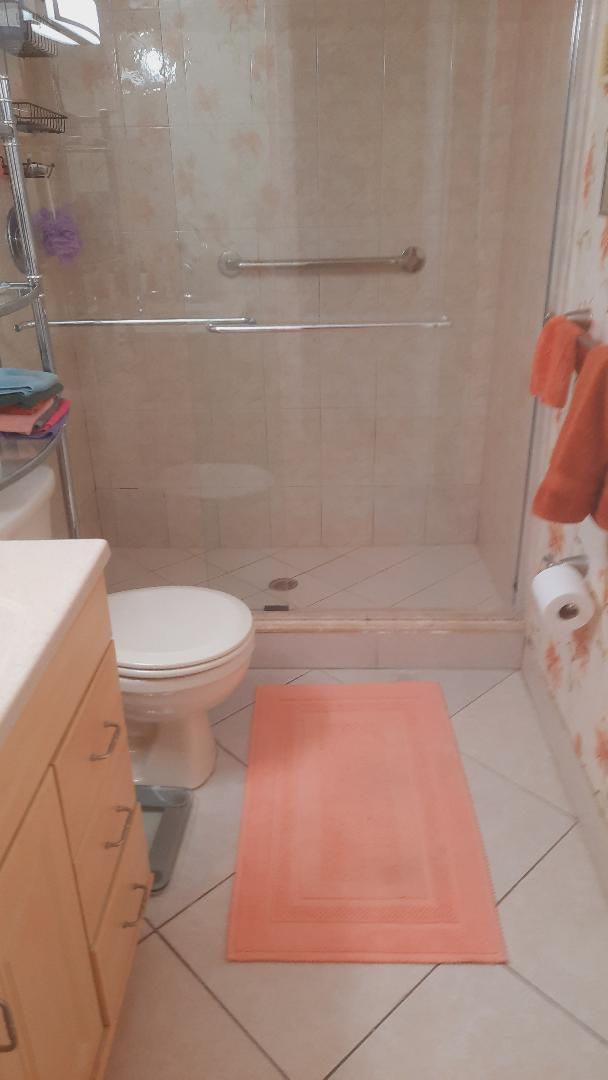 full bath featuring tile patterned floors, a stall shower, and toilet