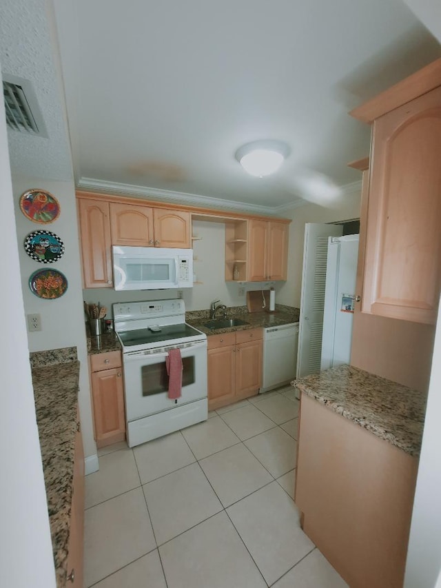 kitchen featuring white appliances, a sink, open shelves, light brown cabinetry, and light stone counters