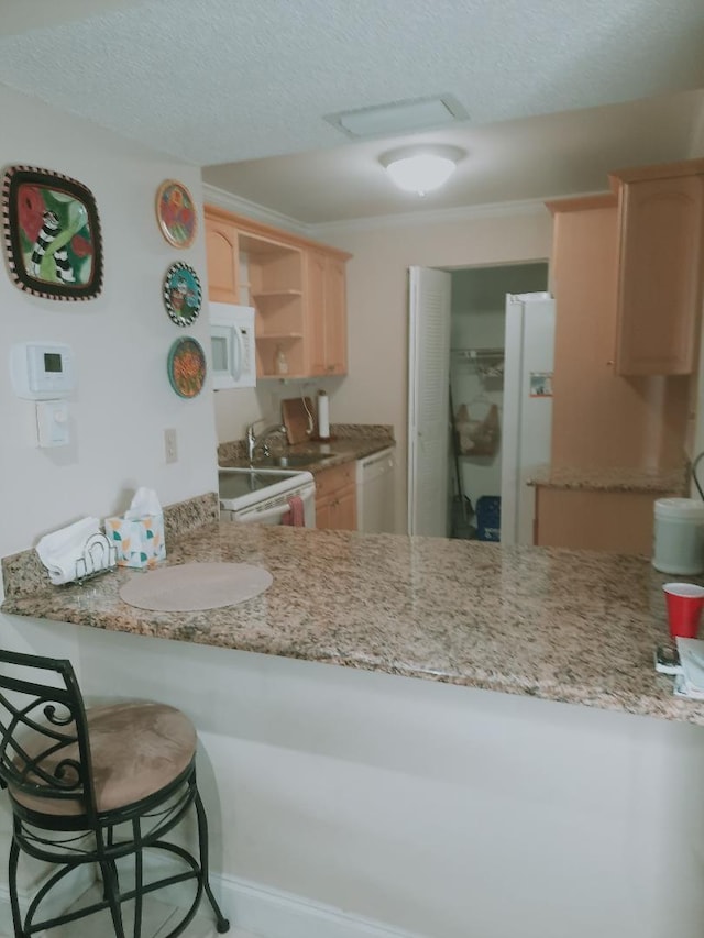 kitchen featuring light brown cabinets, white appliances, open shelves, a textured ceiling, and a peninsula
