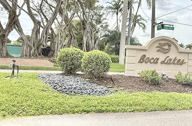 community / neighborhood sign with a lawn