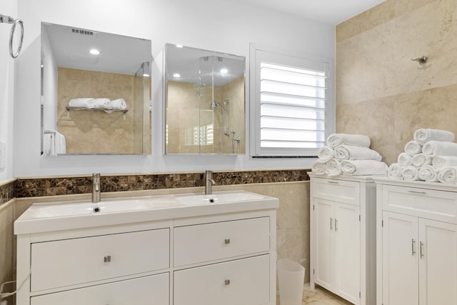 6611 NE 21st Ln, Fort Lauderdale, FL 33308 - bathroom with tile walls, double vanity, a sink, and a stall shower