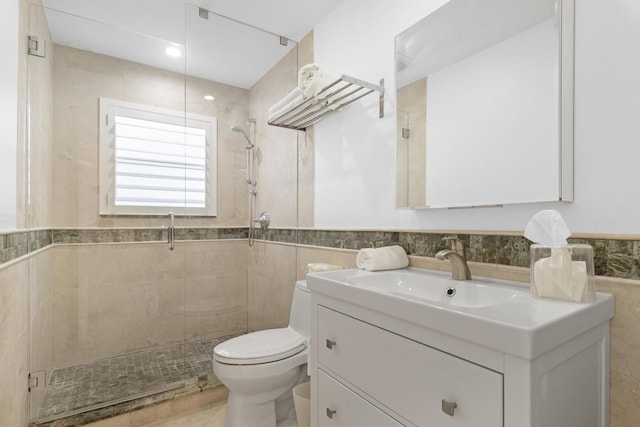 6611 NE 21st Ln, Fort Lauderdale, FL 33308 - bathroom featuring tile walls, toilet, vanity, a stall shower, and wainscoting