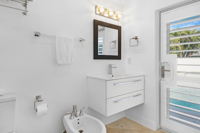 6611 NE 21st Ln, Fort Lauderdale, FL 33308 - bathroom featuring tile patterned floors, vanity, toilet, and a bidet