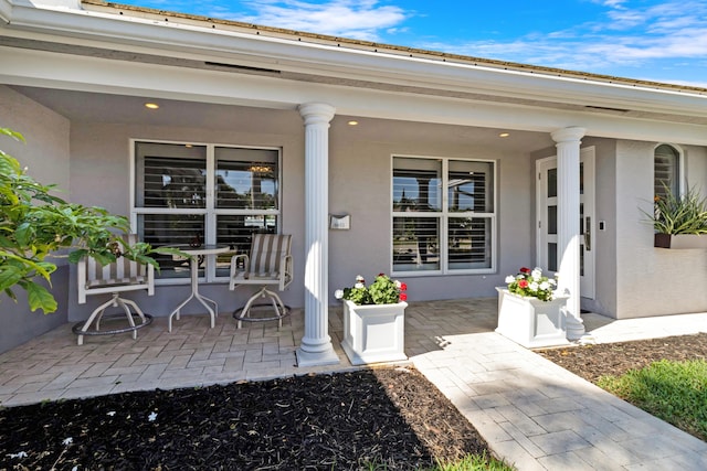 6611 NE 21st Ln, Fort Lauderdale, FL 33308 - doorway to property with stucco siding and a porch
