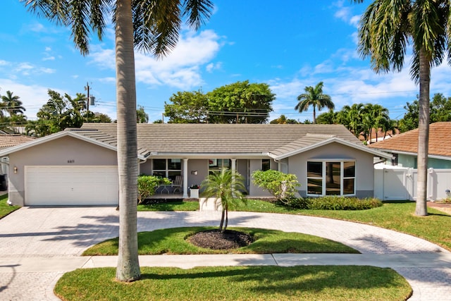 6611 NE 21st Ln, Fort Lauderdale, FL 33308 - view of front of property with curved driveway, stucco siding, fence, a gate, and a front lawn
