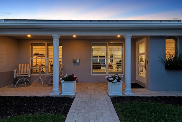 6611 NE 21st Ln, Fort Lauderdale, FL 33308 - view of exterior entry with stucco siding and a porch