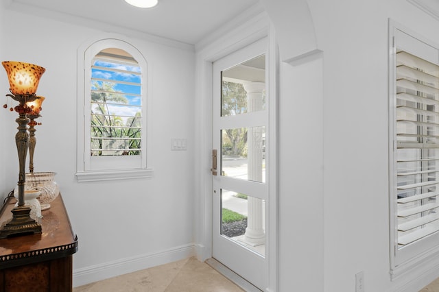 6611 NE 21st Ln, Fort Lauderdale, FL 33308 - doorway featuring light tile patterned flooring, crown molding, and baseboards
