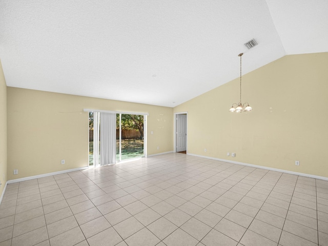 spare room featuring light tile patterned floors, baseboards, visible vents, an inviting chandelier, and lofted ceiling