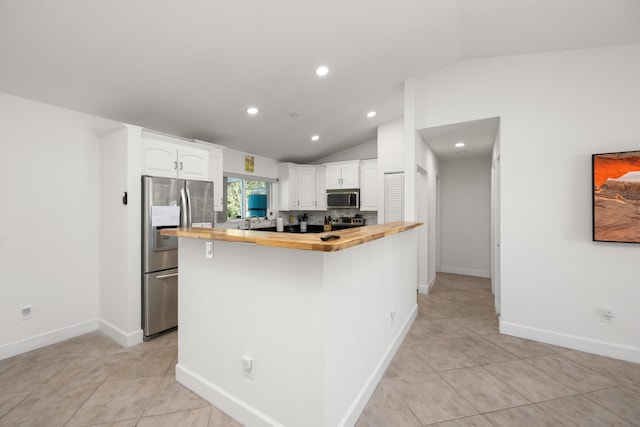 131 NE Naranja Ave, Port Saint Lucie, FL 34983 - kitchen featuring butcher block countertops, white cabinets, appliances with stainless steel finishes, and lofted ceiling