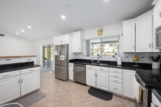 131 NE Naranja Ave, Port Saint Lucie, FL 34983 - kitchen featuring light tile patterned floors, white cabinetry, stainless steel appliances, and a sink