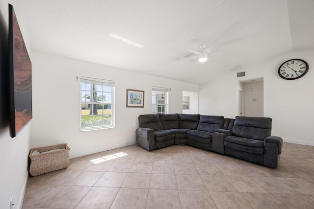 131 NE Naranja Ave, Port Saint Lucie, FL 34983 - living room featuring light tile patterned flooring, visible vents, a ceiling fan, and vaulted ceiling