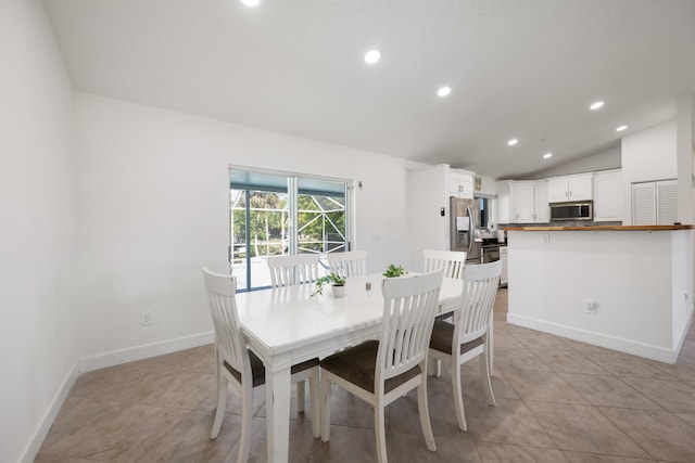131 NE Naranja Ave, Port Saint Lucie, FL 34983 - dining space with recessed lighting, baseboards, light tile patterned flooring, and vaulted ceiling