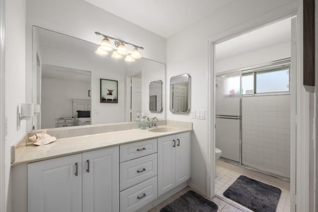 131 NE Naranja Ave, Port Saint Lucie, FL 34983 - ensuite bathroom with vanity, a stall shower, tile patterned flooring, ensuite bathroom, and toilet