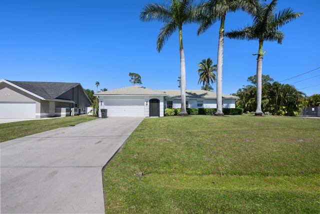 131 NE Naranja Ave, Port Saint Lucie, FL 34983 - ranch-style house featuring a tiled roof, an attached garage, concrete driveway, and a front yard