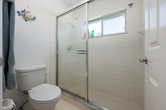131 NE Naranja Ave, Port Saint Lucie, FL 34983 - bathroom featuring tile patterned floors, toilet, and a stall shower