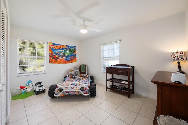 131 NE Naranja Ave, Port Saint Lucie, FL 34983 - bedroom featuring light tile patterned floors, multiple windows, and baseboards