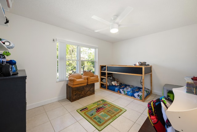 131 NE Naranja Ave, Port Saint Lucie, FL 34983 - tiled bedroom featuring a ceiling fan, baseboards, and a textured ceiling