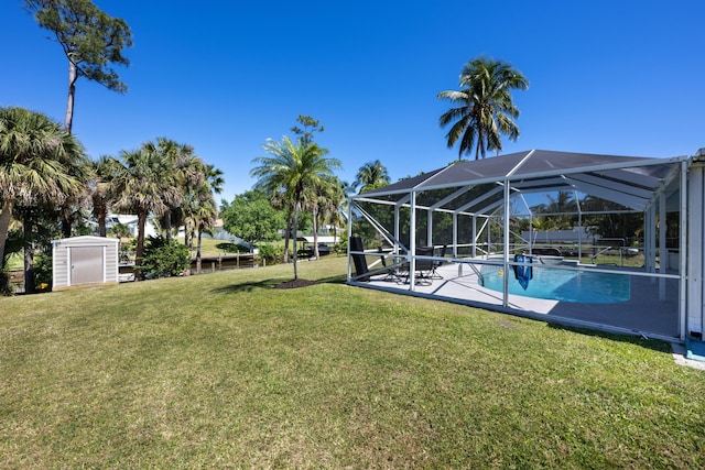 131 NE Naranja Ave, Port Saint Lucie, FL 34983 - view of yard with glass enclosure, a storage shed, an outbuilding, and an outdoor pool
