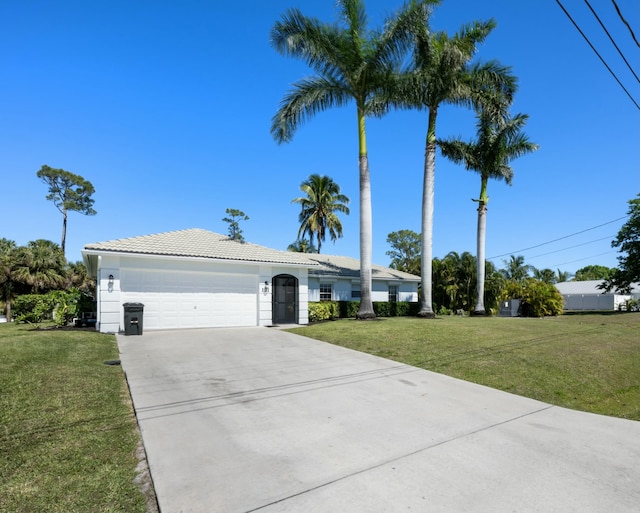 131 NE Naranja Ave, Port Saint Lucie, FL 34983 - view of front of house with a front yard, a tiled roof, an attached garage, and driveway