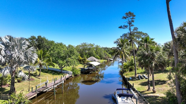 131 NE Naranja Ave, Port Saint Lucie, FL 34983 - dock area featuring a water view and boat lift