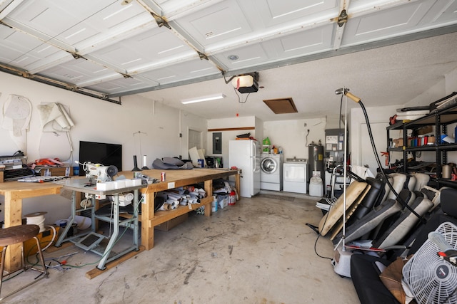 131 NE Naranja Ave, Port Saint Lucie, FL 34983 - garage featuring electric panel, freestanding refrigerator, a workshop area, a garage door opener, and independent washer and dryer