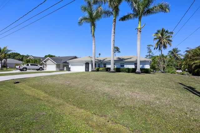 131 NE Naranja Ave, Port Saint Lucie, FL 34983 - view of front of home with an attached garage, concrete driveway, and a front yard