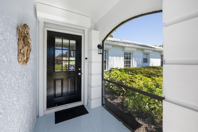 131 NE Naranja Ave, Port Saint Lucie, FL 34983 - doorway to property with stucco siding and a tile roof
