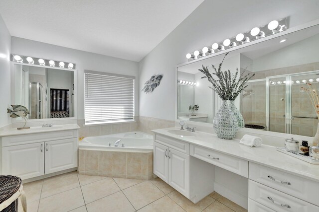 bathroom featuring a sink, a stall shower, tile patterned floors, and a bath