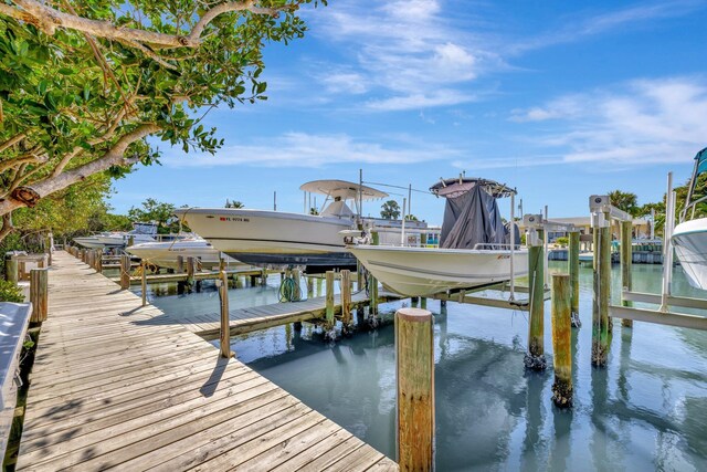 view of dock with boat lift and a water view