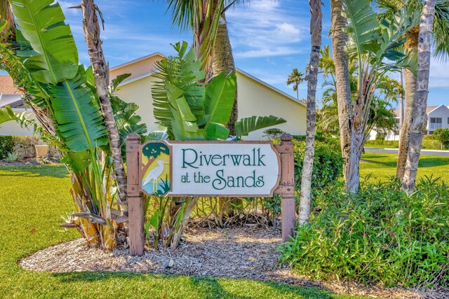 community / neighborhood sign with a lawn