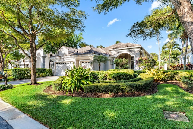 16137 Via Monteverde, Delray Beach, FL 33446 - mediterranean / spanish-style house with a tiled roof, an attached garage, stucco siding, a front lawn, and driveway