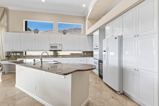 16137 Via Monteverde, Delray Beach, FL 33446 - kitchen with white appliances, ornamental molding, dark stone countertops, white cabinetry, and a sink