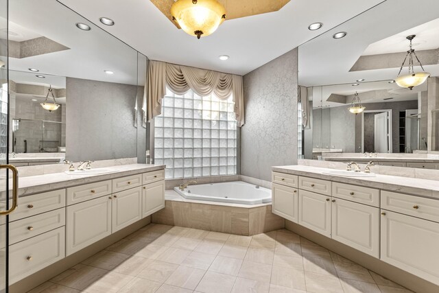 16137 Via Monteverde, Delray Beach, FL 33446 - full bath with two vanities, a sink, a stall shower, and a garden tub
