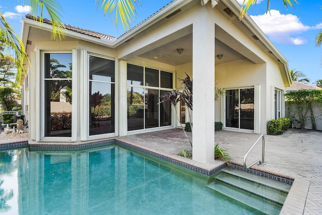 16137 Via Monteverde, Delray Beach, FL 33446 - back of property featuring a patio, stucco siding, and an outdoor pool