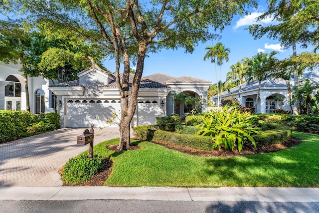 16137 Via Monteverde, Delray Beach, FL 33446 - mediterranean / spanish home with a tile roof, stucco siding, an attached garage, decorative driveway, and a front yard