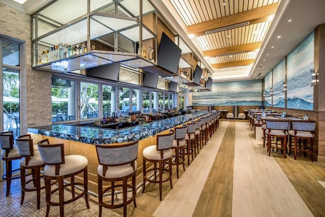 16137 Via Monteverde, Delray Beach, FL 33446 - bar featuring a towering ceiling, wood finished floors, wet bar, and beamed ceiling