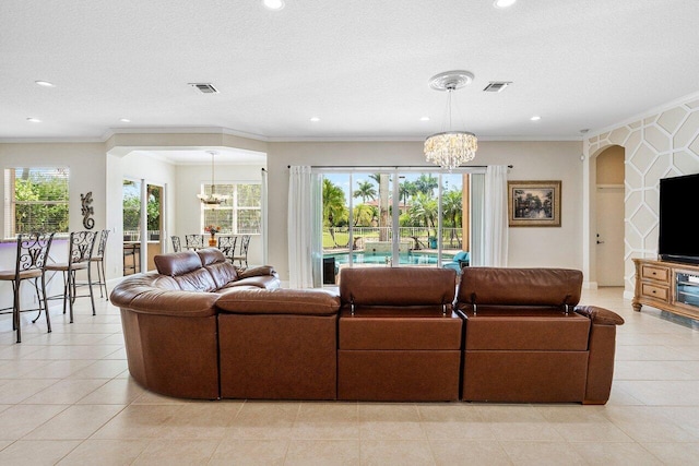 living room with arched walkways, recessed lighting, and an inviting chandelier