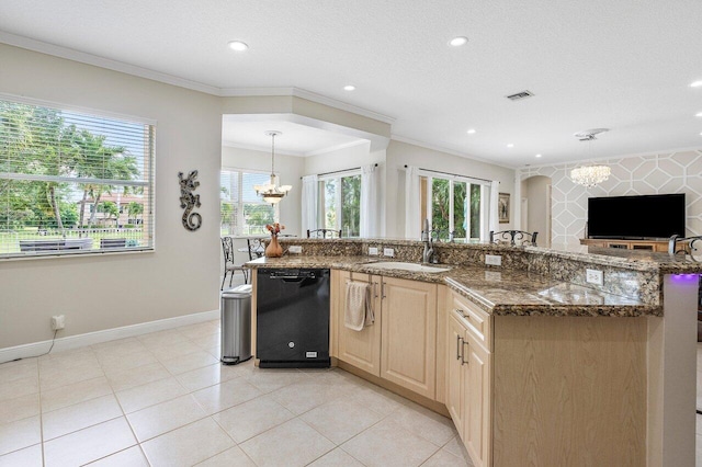 kitchen featuring dishwasher, a notable chandelier, ornamental molding, and a healthy amount of sunlight