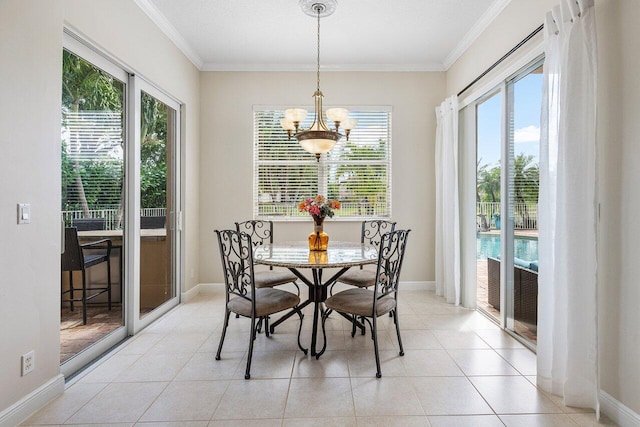 dining room with light tile patterned flooring, baseboards, a notable chandelier, and crown molding