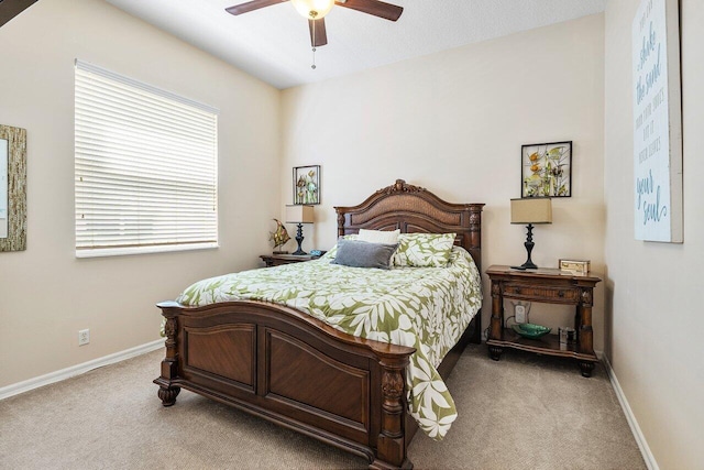 carpeted bedroom with baseboards and a ceiling fan