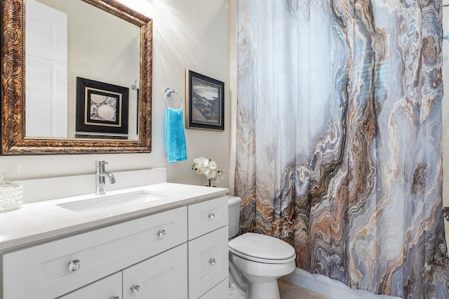 bathroom with toilet, vanity, and a shower with shower curtain
