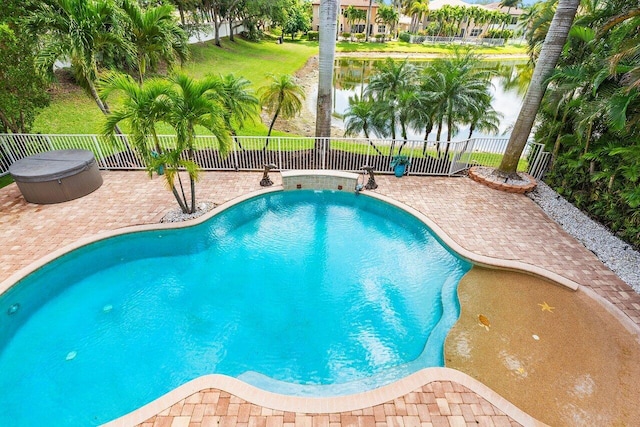 view of swimming pool with a fenced backyard, a water view, a patio area, and a fenced in pool