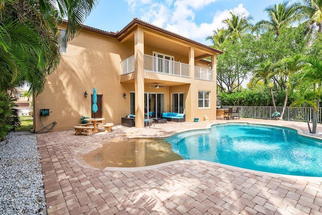 view of pool with fence, a patio area, a fenced in pool, and ceiling fan