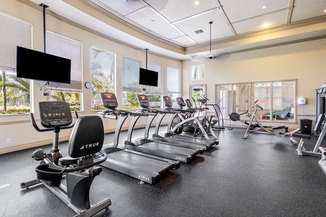 exercise room with visible vents, a wealth of natural light, recessed lighting, and ornamental molding