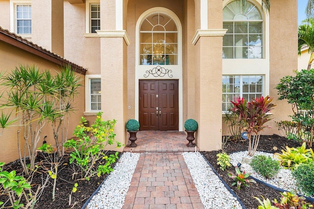 property entrance with stucco siding