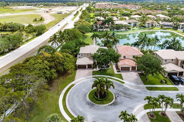 drone / aerial view featuring a residential view and a water view