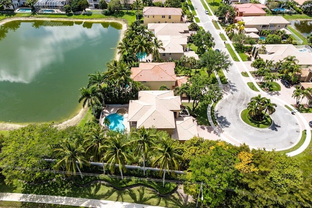 drone / aerial view with a residential view and a water view