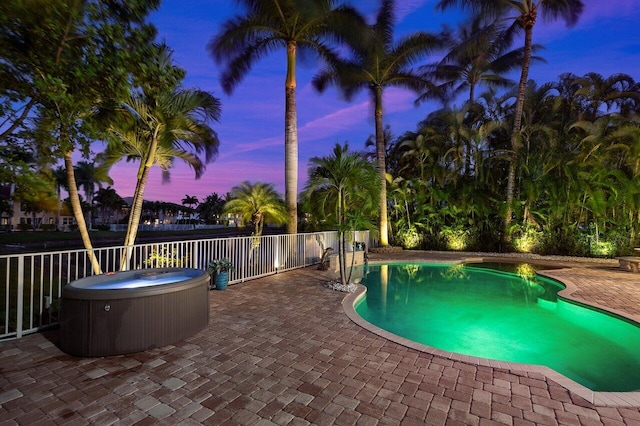 view of pool featuring a fenced in pool, a hot tub, and a patio